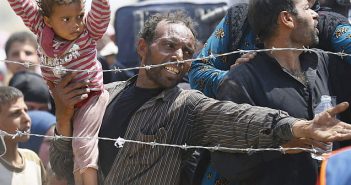 Refugees behind barbed wire